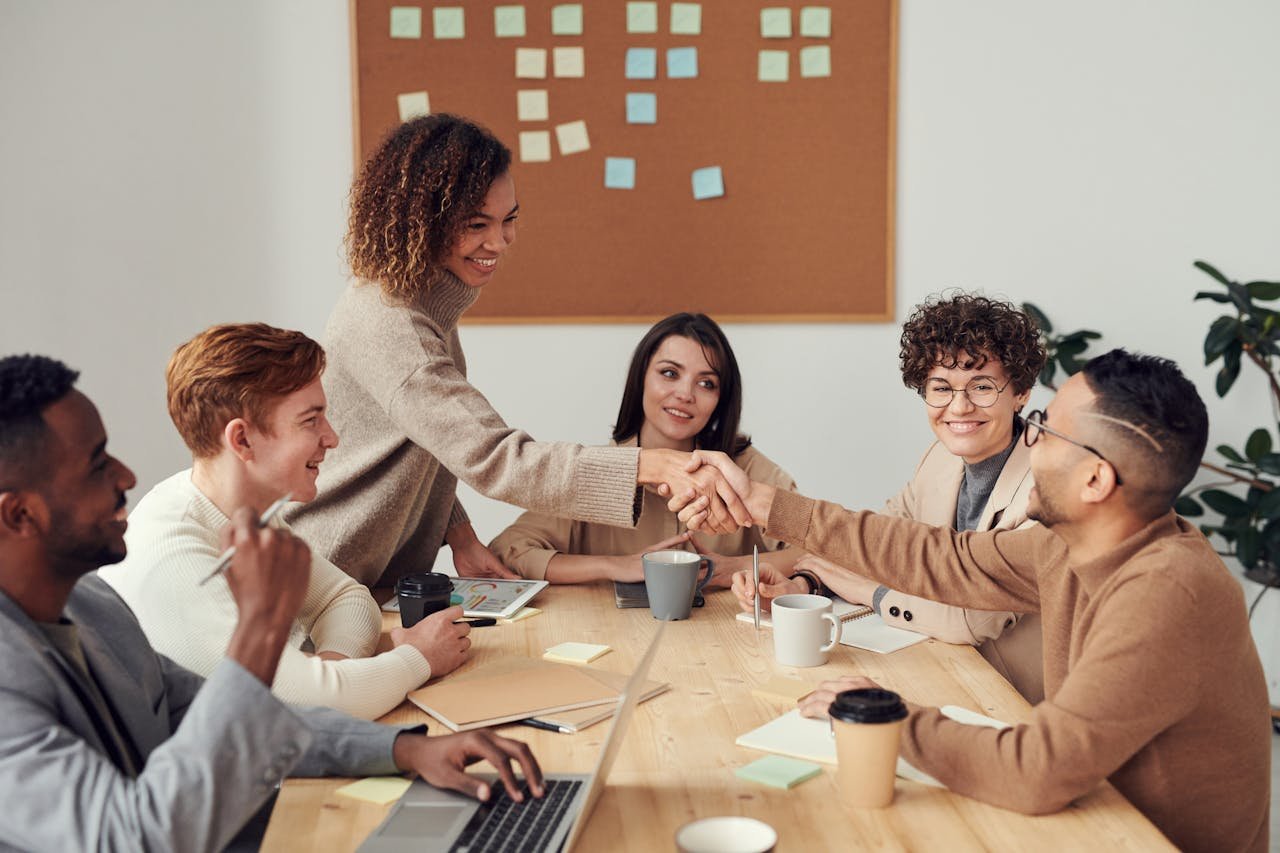 About Diverse team collaborating in a meeting, showcasing teamwork and cooperation in a modern workplace.